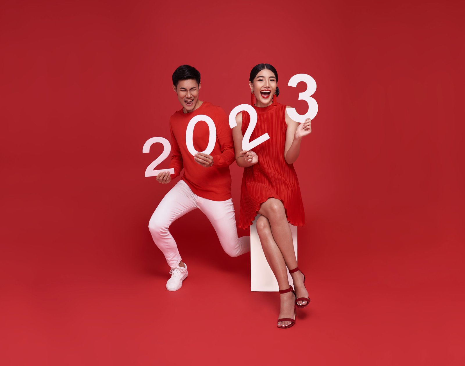 happy-asian-couple-red-casual-attire-showing-number-2023-greeting-happy-new-year